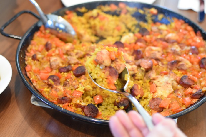 Serving Spanish Paella with chorizo, chicken, and saffron | BeatsEats.com