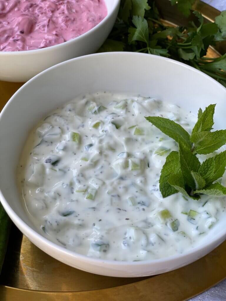 Close-up of creamy Persian yogurt and cucumber dip garnished with mint