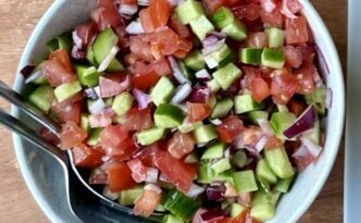 Fresh Salad Shirazi in a white bowl with chopped cucumber, tomato, and onion