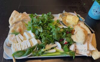 Sabzi khordan platter of fresh herbs with cheese, butter, and vegetables. Side or starter for Persian meal.