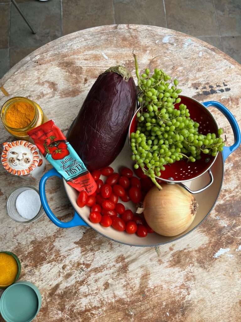 Ingredients for Air Fryer Khoresht Bademjan including eggplant, tomatoes, onion, tomato paste, turmeric and ghooreh
