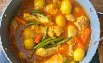 Persian Khorak Morgh chicken and vegetable stew simmering on the stovetop