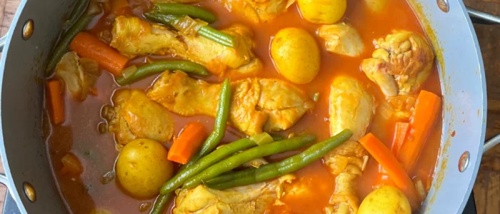 Persian Khorak Morgh chicken and vegetable stew simmering on the stovetop